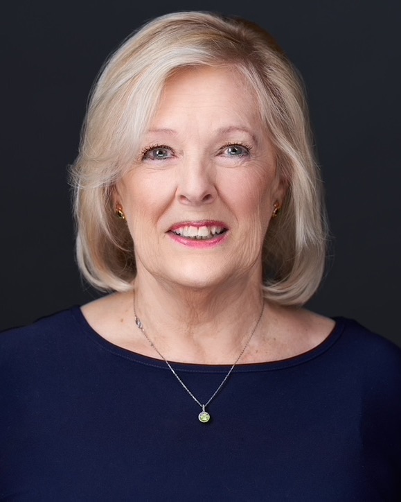 Joyce Sikora, owner of Winnipeg Pet Nanny, smiling in a studio portrait